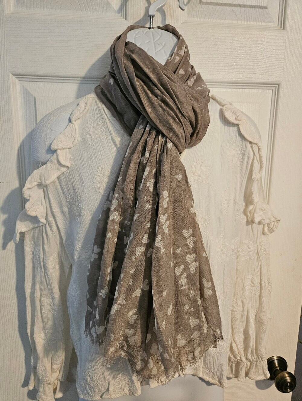 Woman's light gray scarf with white hearts